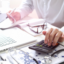 Healthcare costs and fees concept.Hand of smart doctor used a ca Healthcare costs and fees concept.Hand of smart doctor used a ca