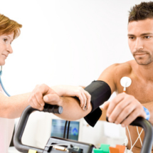 Nurse makes the patient ready for medical EKG test.